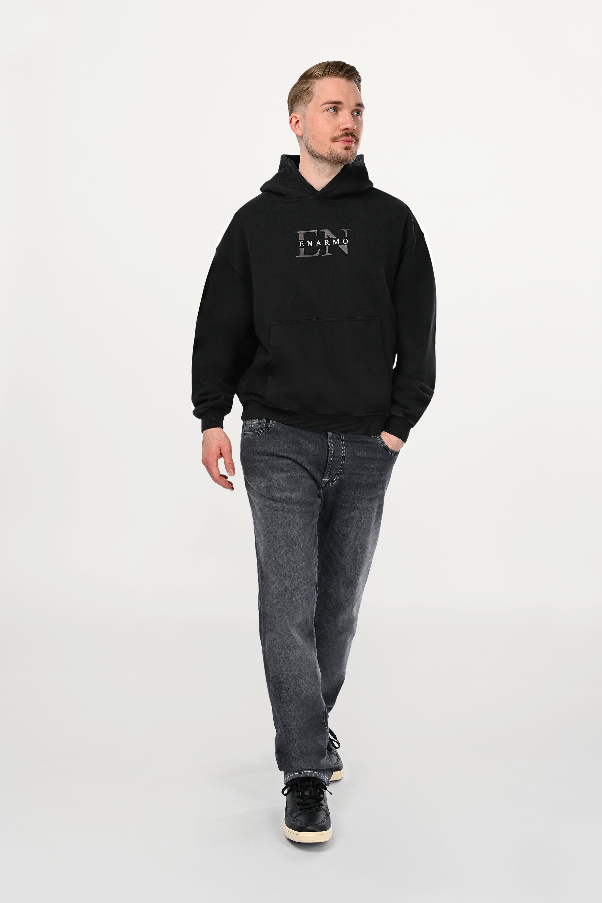 Male model wearing mid grey regular fit denim jeans with clean neutral wash and classic five-pocket design, modern designer denim front view.