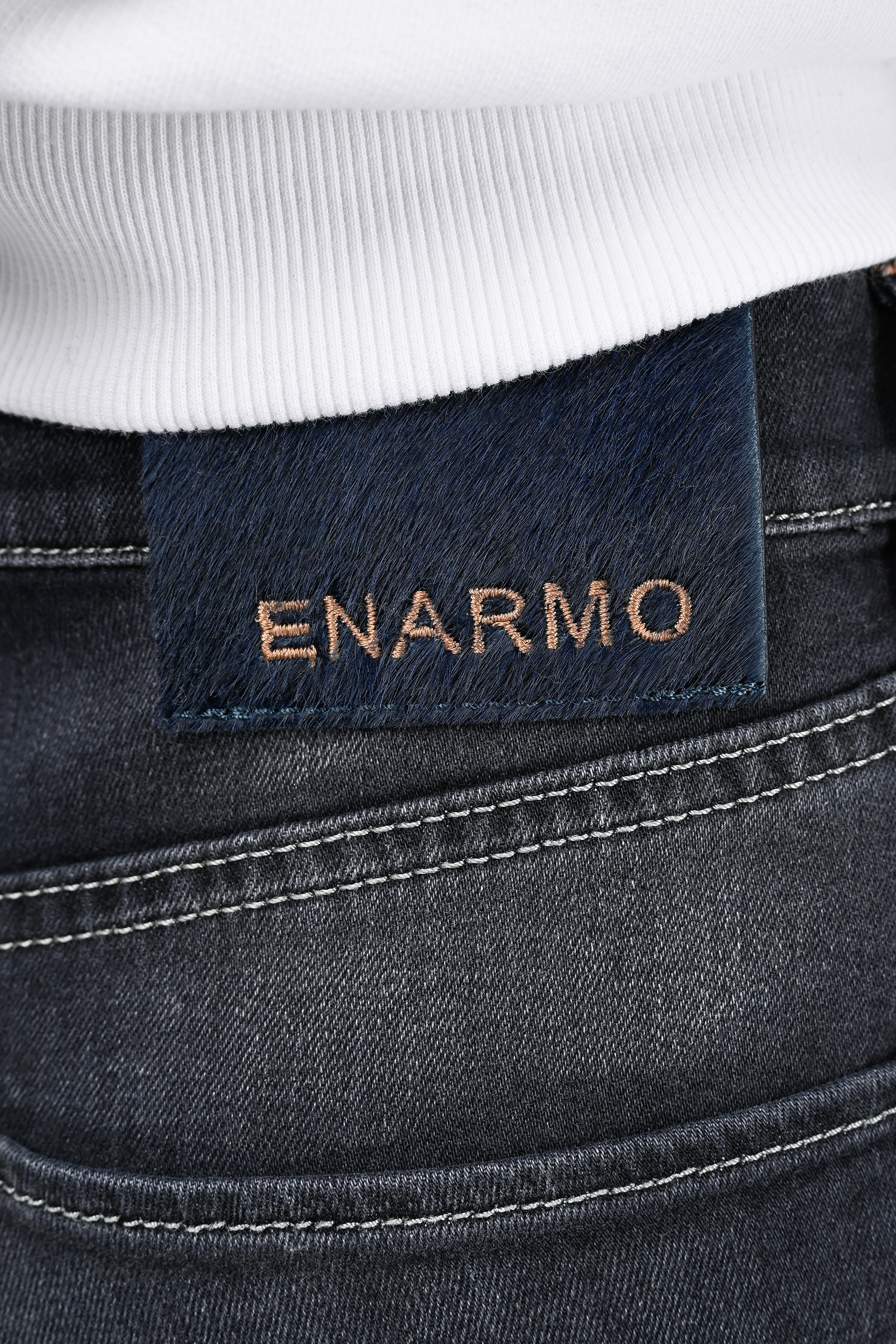 Detailed close-up of rear waistband featuring pony hair patch with ENARMO embroidery on mid grey regular fit women’s jeans.