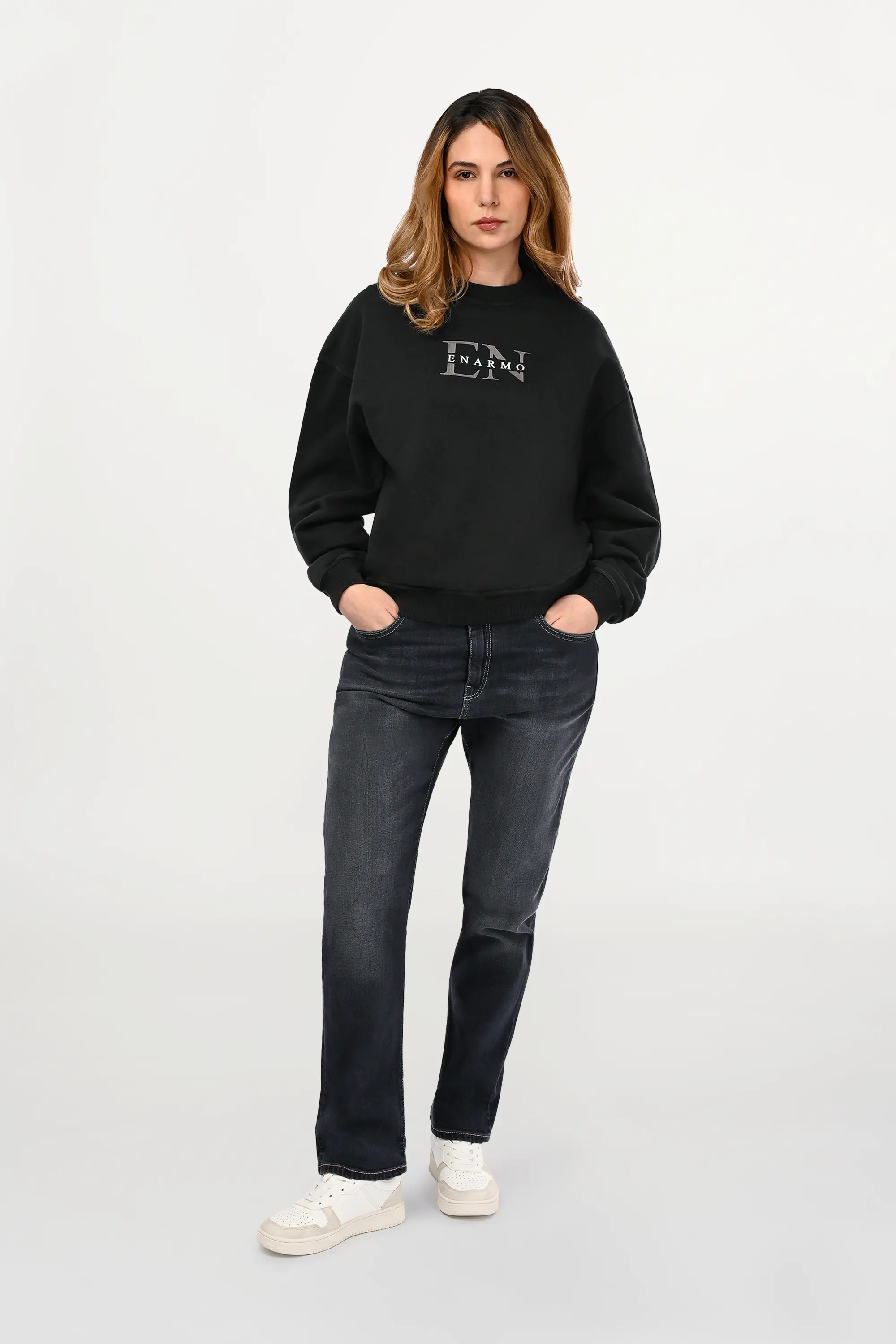 Female model wearing mid grey regular fit jeans with balanced straight silhouette and soft faded wash, modern women’s designer denim front view.