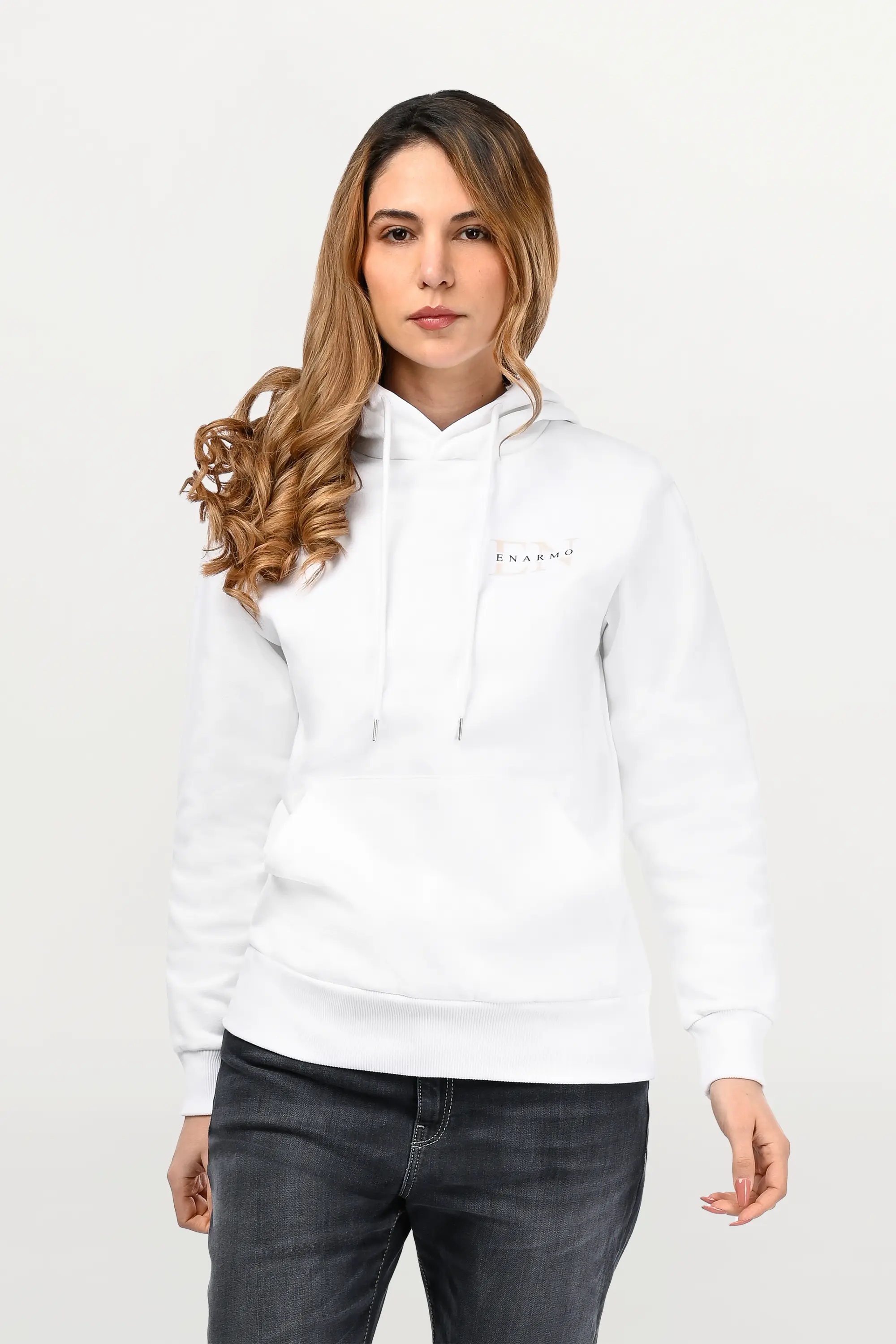 Close-up of beige EN monogram with black ENARMO lettering printed on white cotton hoodie, detailed chest logo on premium fabric.