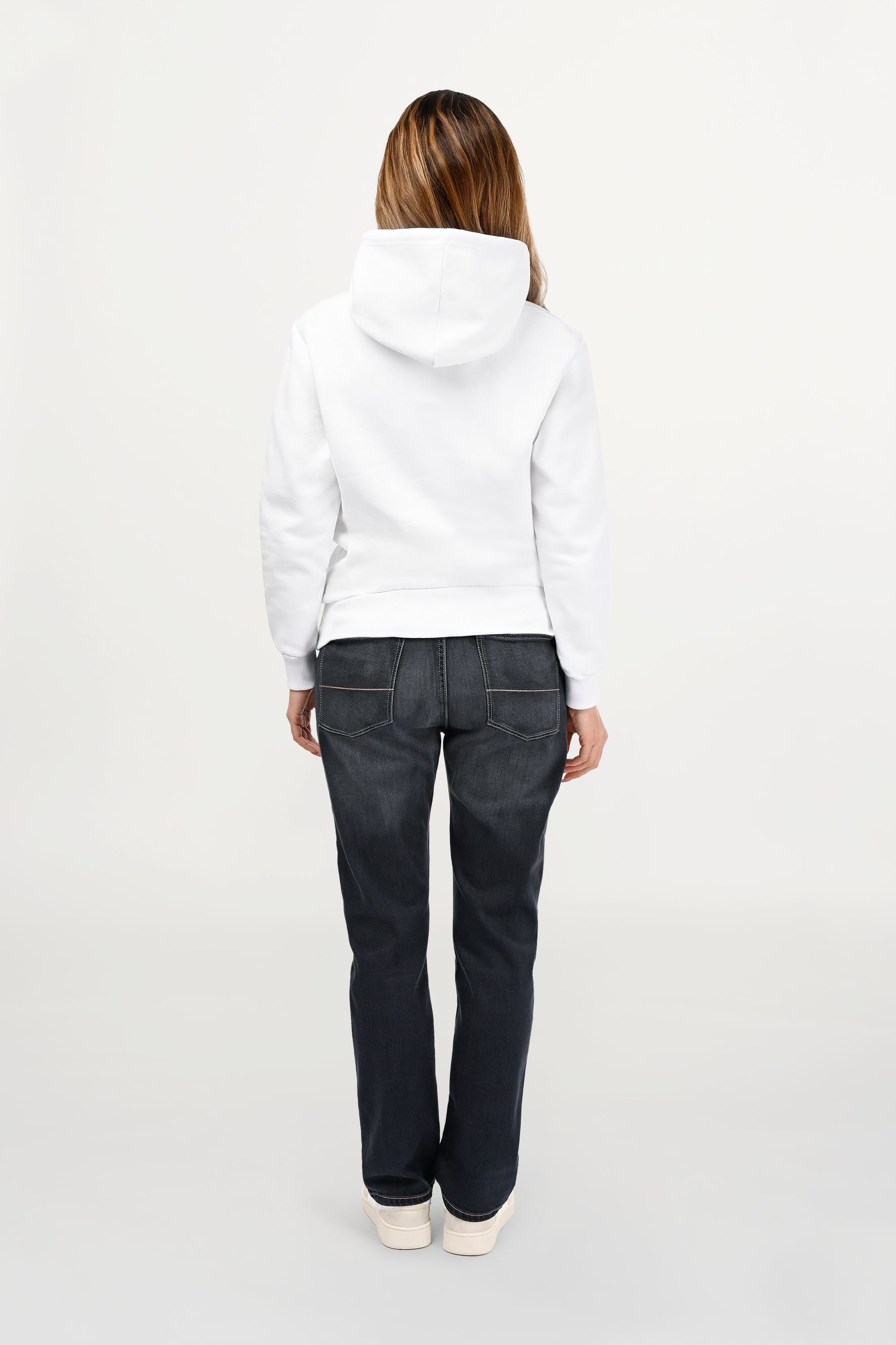 Rear view of female model in white designer hoodie, smooth back panel with structured regular cut and clean contemporary styling.