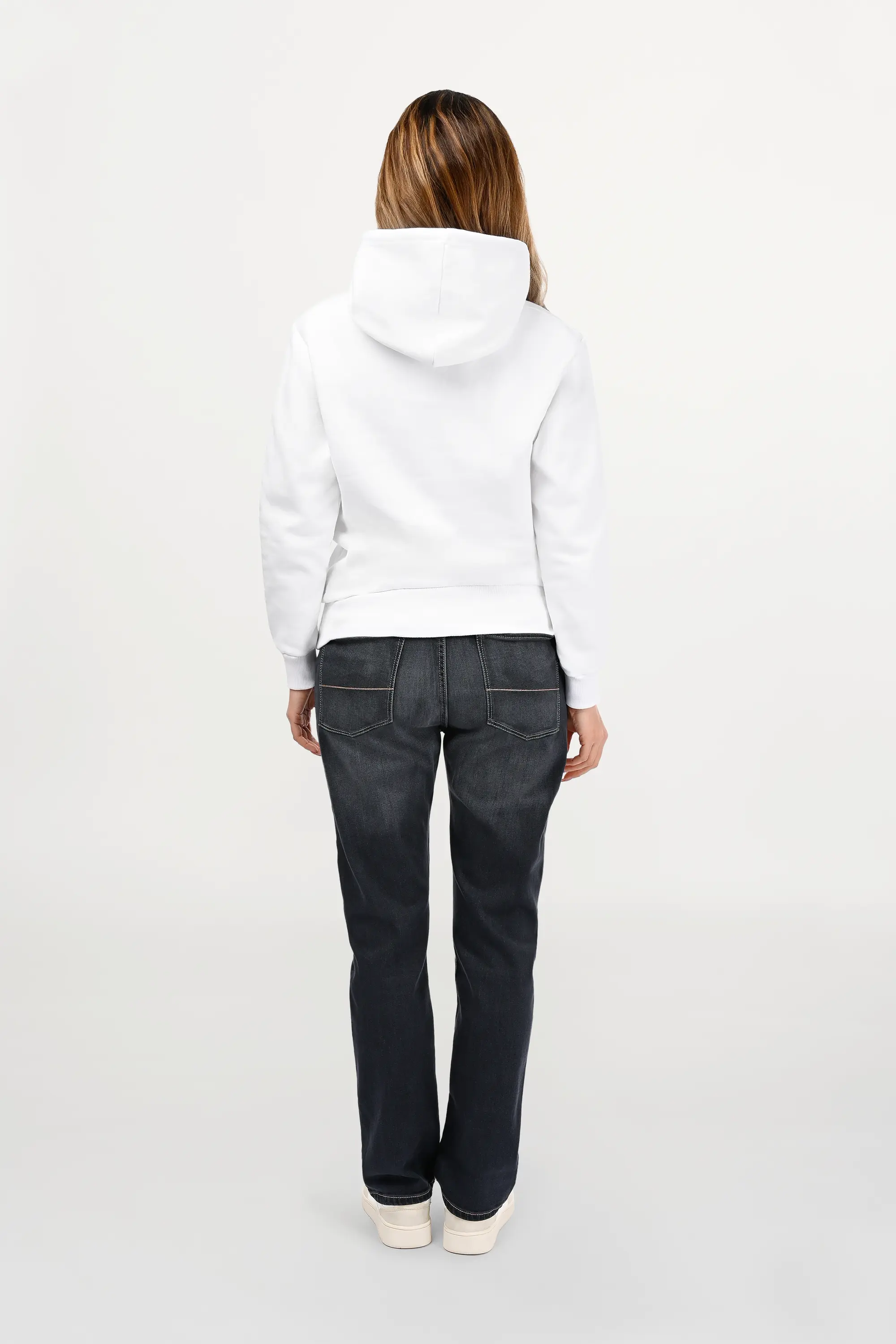 Rear view of female model in white designer hoodie, smooth back panel with structured regular cut and clean contemporary styling.