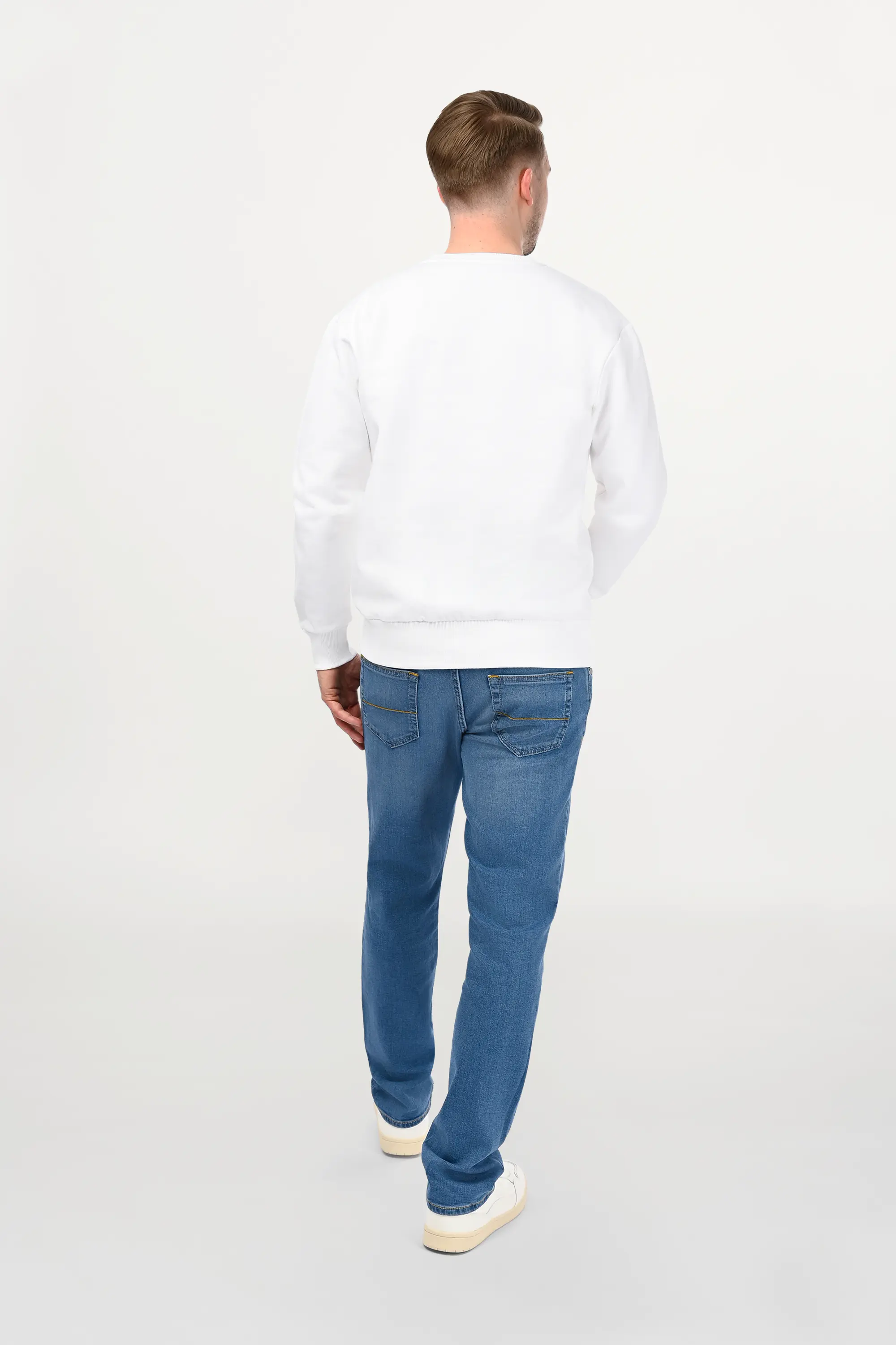 Rear view of male model in white ENARMO sweatshirt, smooth back panel, balanced proportions and classic unisex cut.