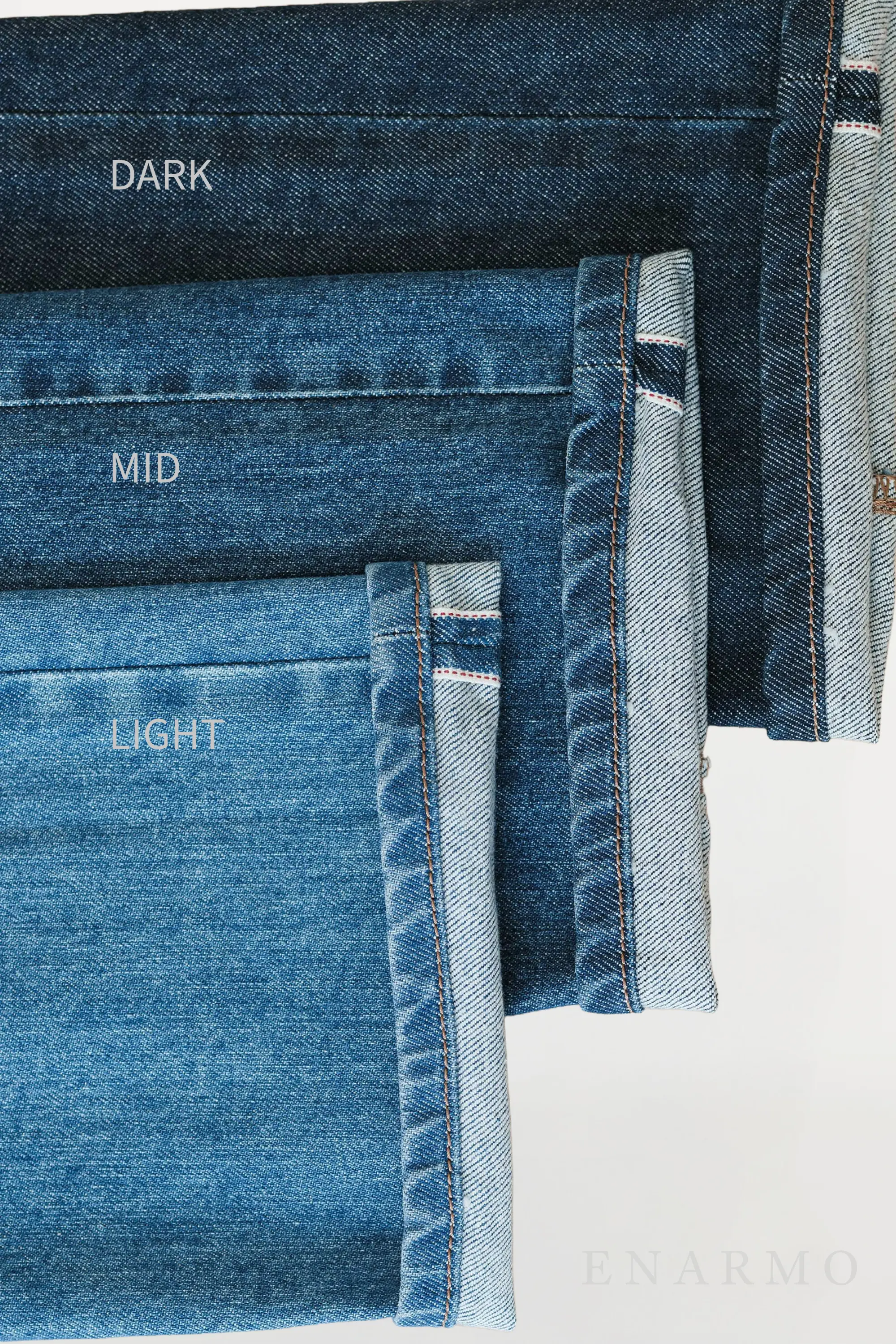 Close up showcasing 3 selvedge Jeans in 3 different blue tones: light, mid and dark blue
