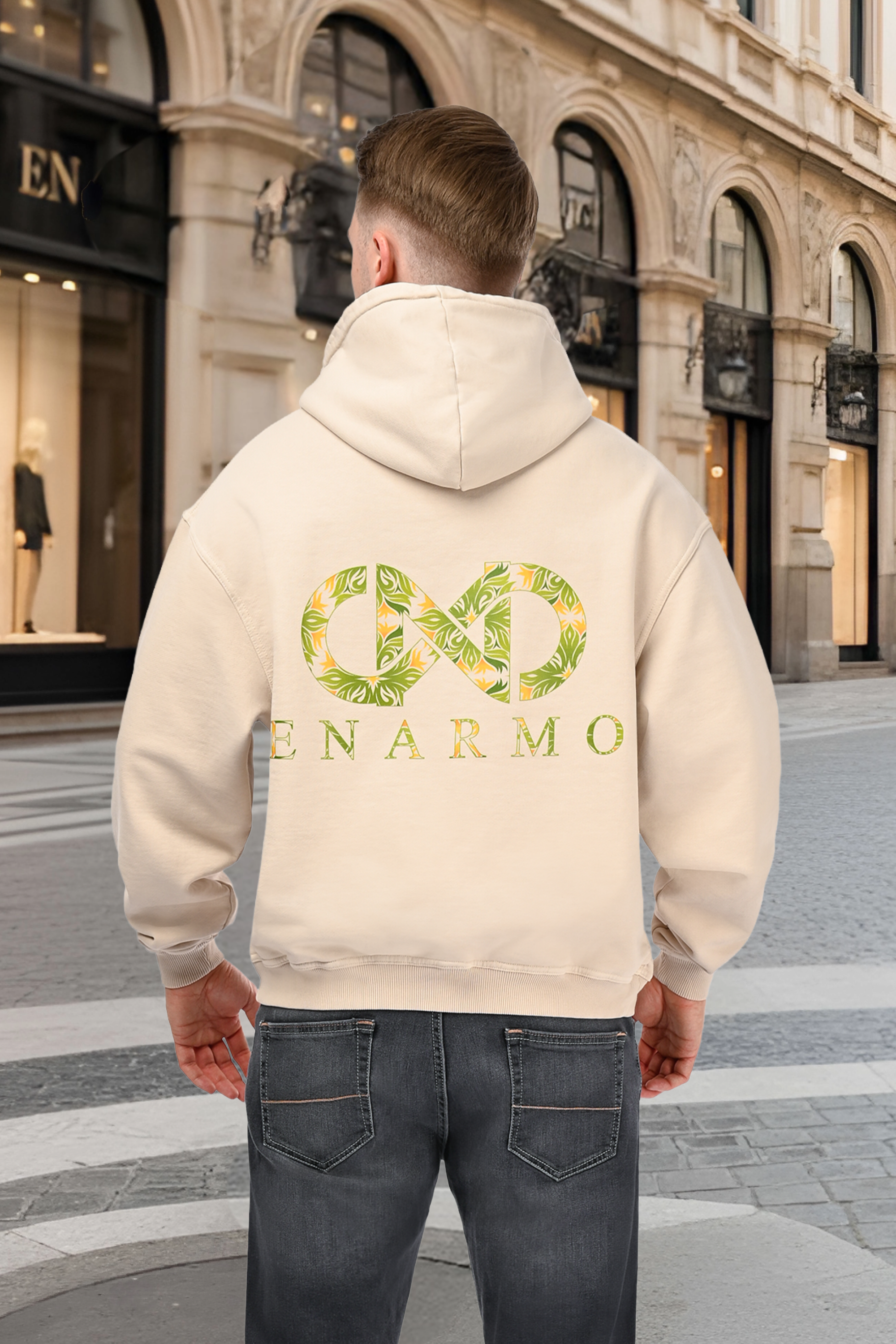Luxury unisex oversized beige hoodie worn by a man, back view with bold green and yellow logo motif
