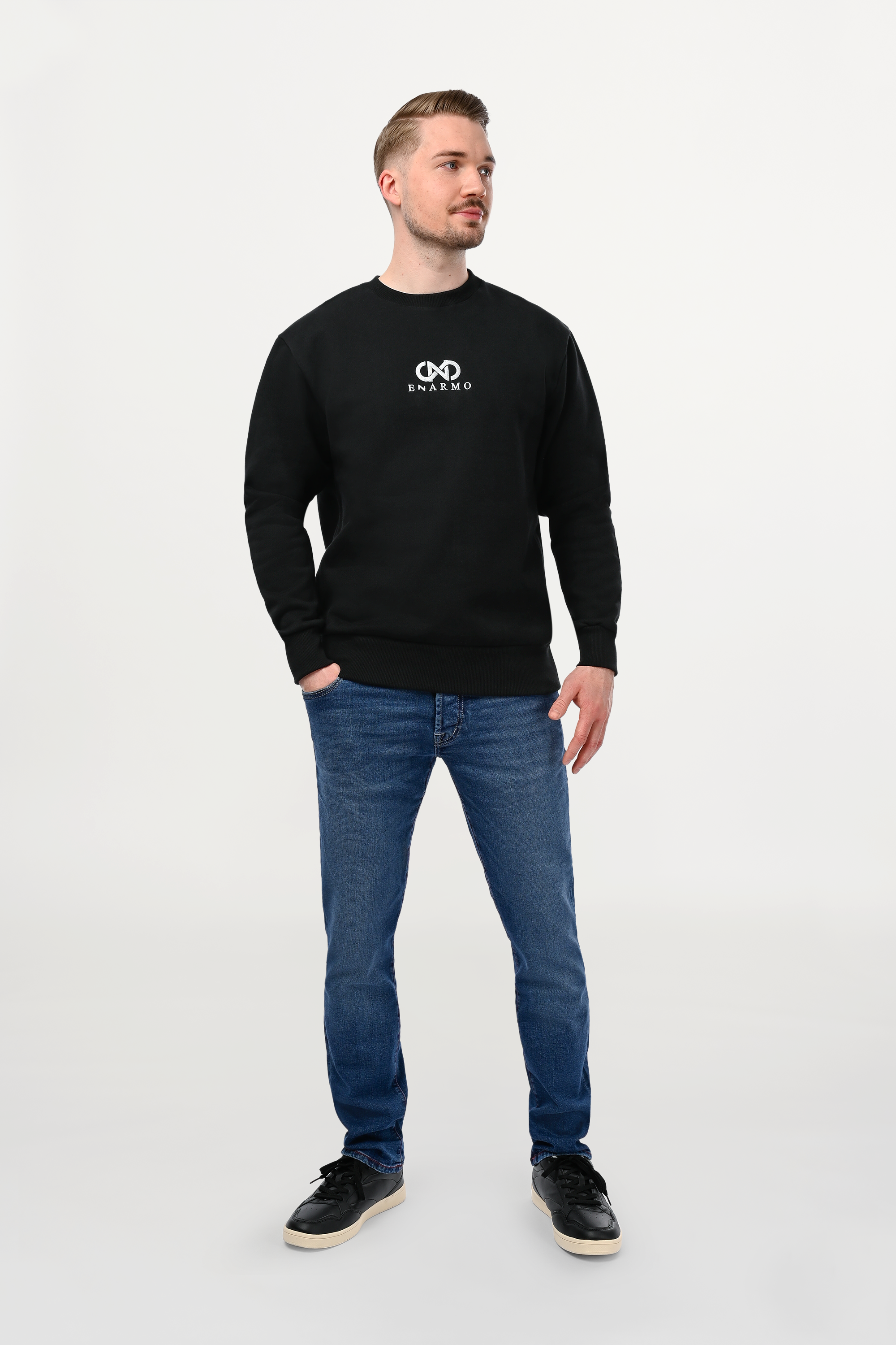 Male model wearing slim fit  premium jeans, with subtle wash, front view, refined minimalist styling.