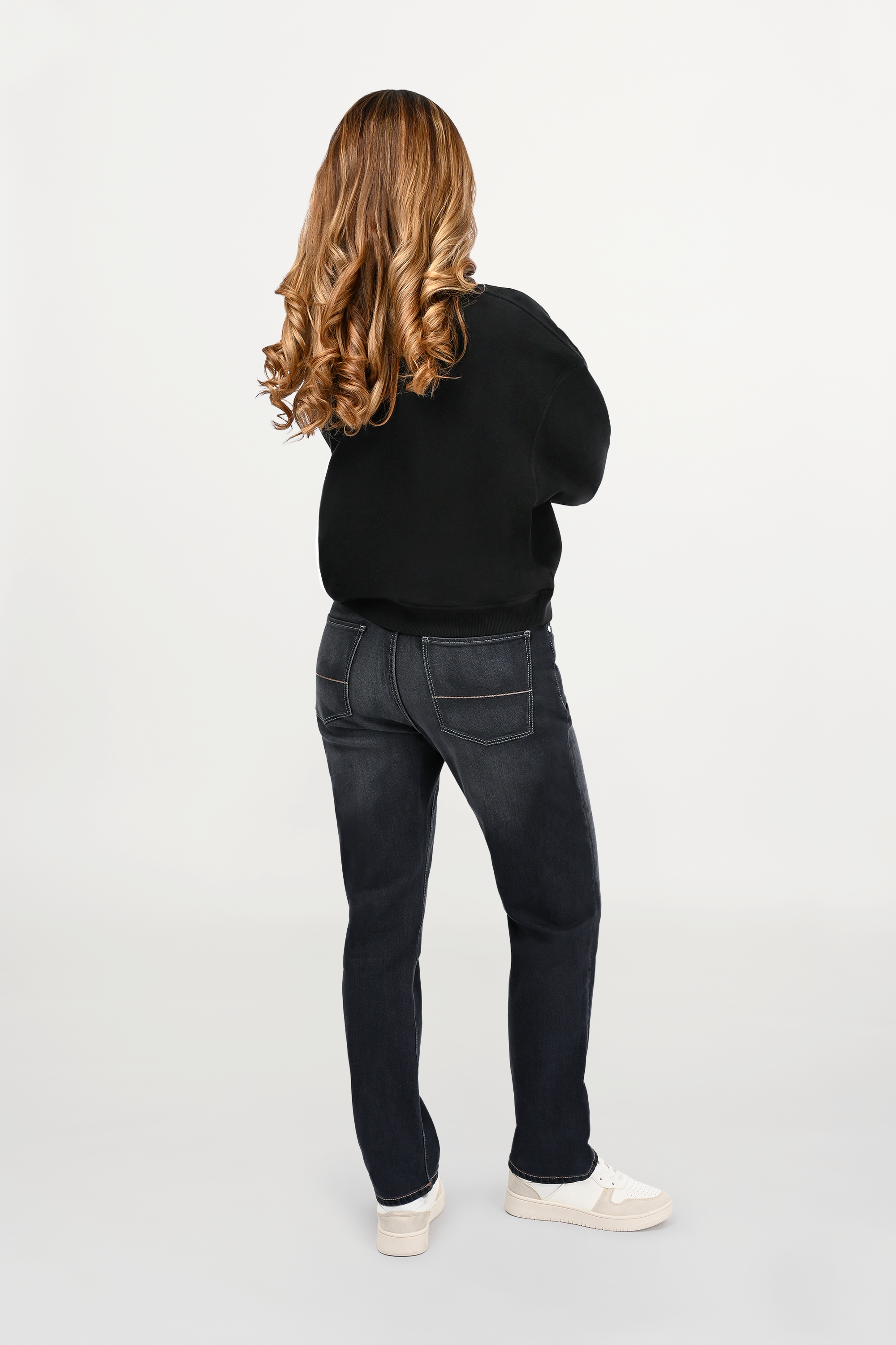 Back view of female model wearing mid grey regular fit denim jeans featuring classic back pockets and clean structured waistband.