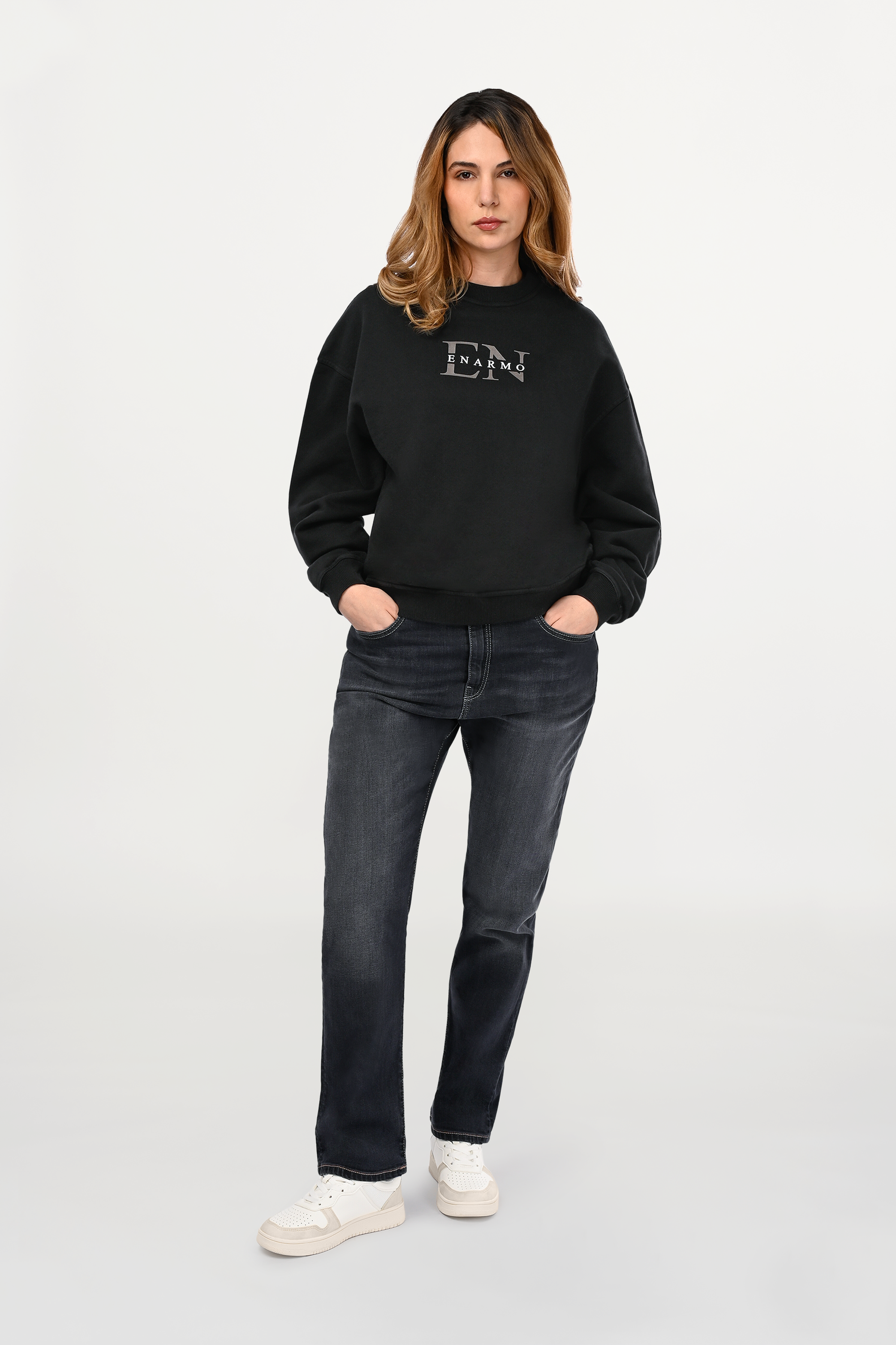 Female model wearing mid grey regular fit jeans with balanced straight silhouette and soft faded wash, modern women’s designer denim front view.