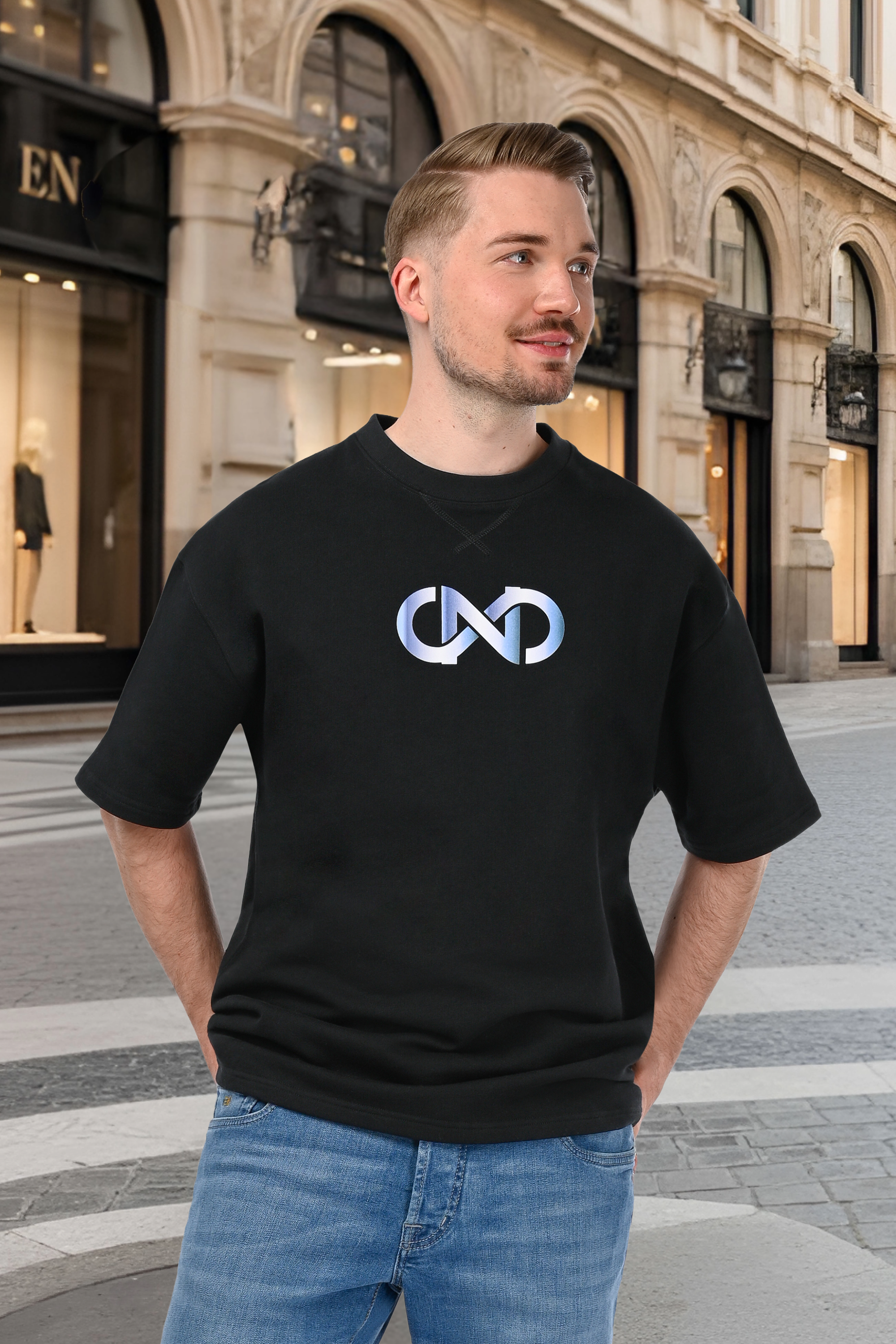 Luxury unisex oversized black T-shirt worn by a man with blue gradient logo print