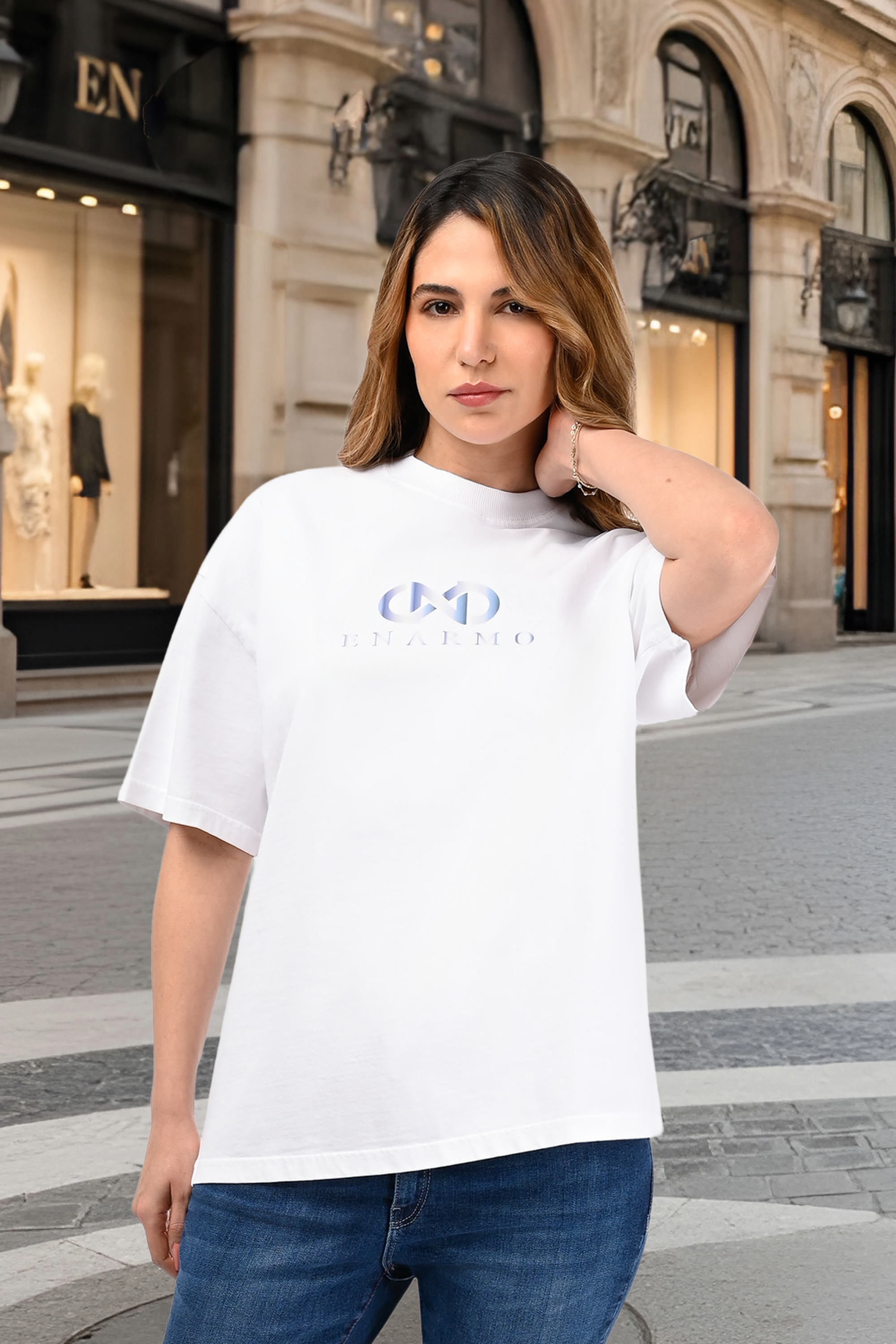 Luxury unisex oversized white cotton T-shirt worn by a woman with blue gradient logo print